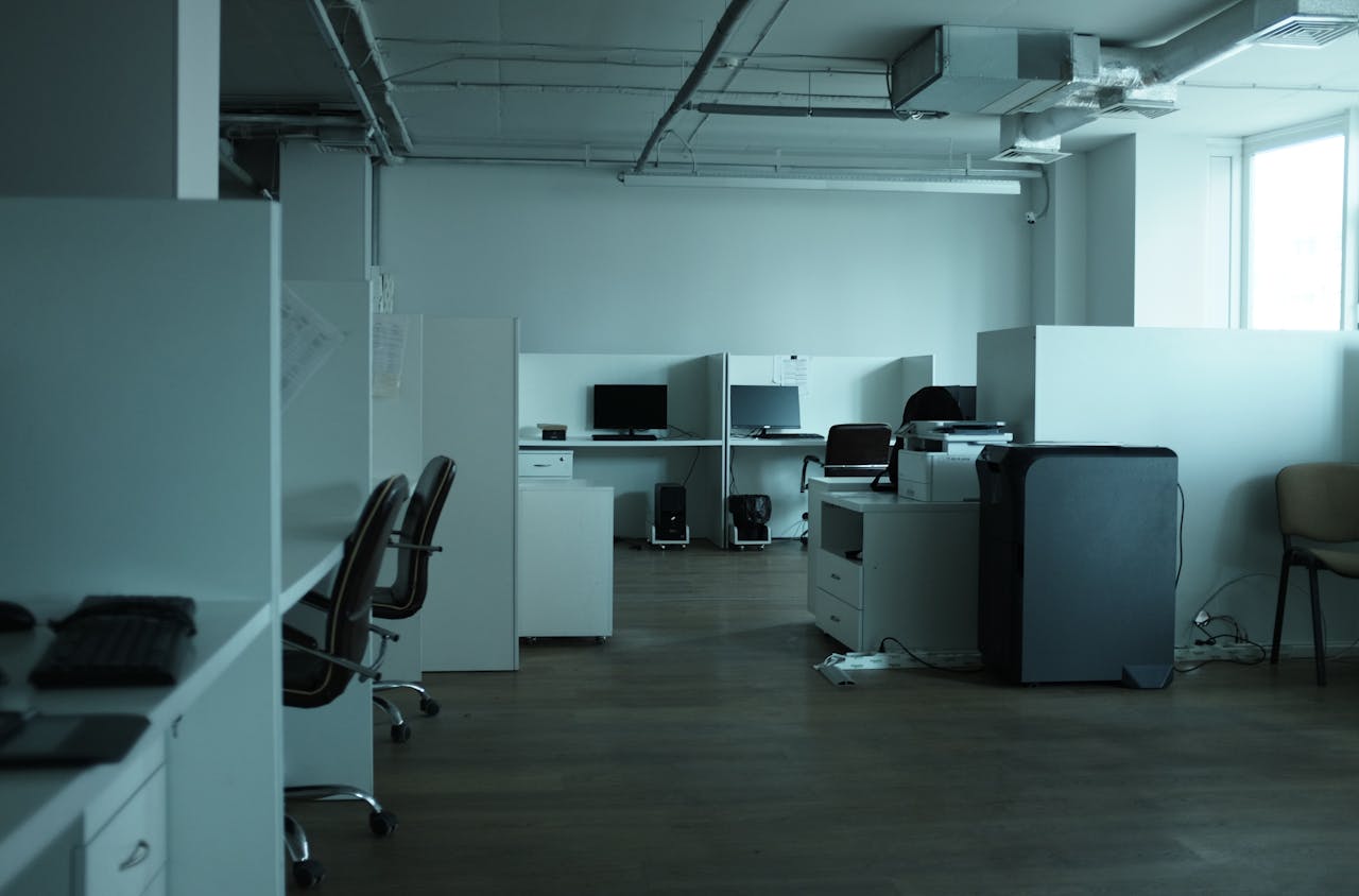 An empty modern office space in Kyiv featuring workstations, chairs, and technology.